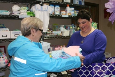 Melissa Ziegenhorn is known as the &quot;Blanket Lady&quot; at Arkansas Pregnancy Resource Center. She&#039;s seen here handing off blankets to center volunteer Joan Wehr. 