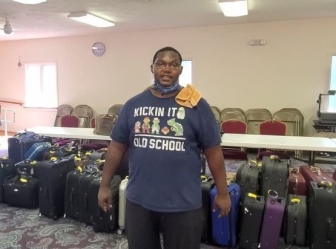 Pastor Sean Burch with suitcases he&#039;s collected for Suitcases With Hope
