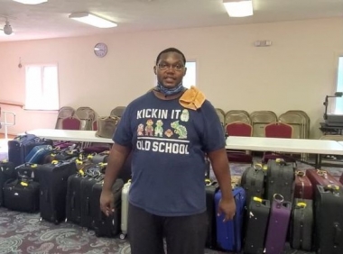 Pastor Sean Burch with suitcases he&#039;s collected for Suitcases With Hope