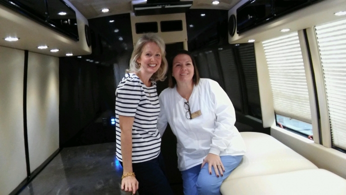 Jennifer Gunderman, APRC&#039;s Board President (left) with Theresa Suffern, APRC&#039;s Nurse Manager, in a Save the Storks bus, which they hope to bring to Little Rock by Dec. 2017.