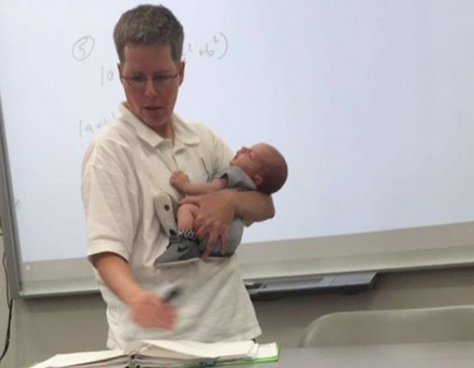 Professor Josie Ryan holds Sarah Thompson’s son Isaiah while teaching Thompson&#039;s math class at Lander University