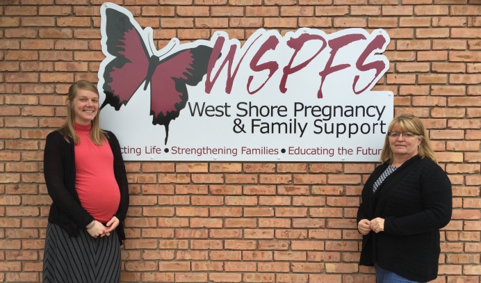 Heather Bush (L) and Barb Hernandez in front of the new sign for West Shore Pregnancy &amp; Family Support.