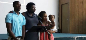 Rhonda Darville (second from left) joins family sharing their testimony at GodParent Center&#039;s opening event June 2
