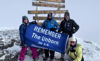 Bishop Coffey, Dr. Pat Castle, Bernadette Costello, and Dolores Meehan with LIFE Runners&#039; “REMEMBER The Unborn” message atop Mt. Kilimanjaro (19,341 ft.) 
