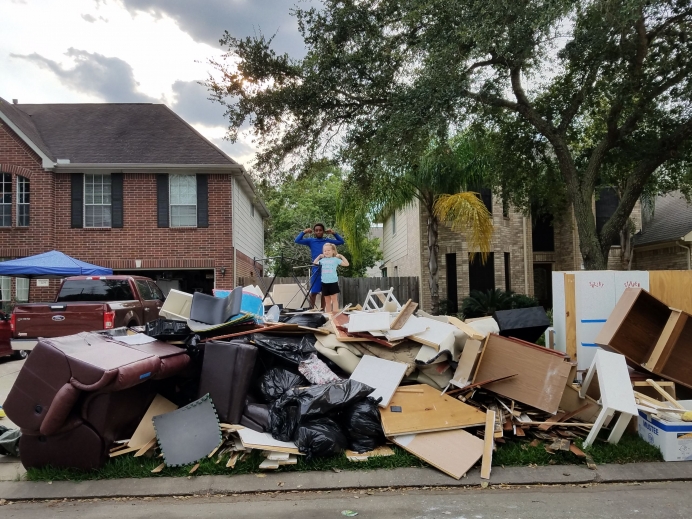 Debbie Simmons&#039; oldest grandchild and youngest child atop the rubble of the Simmons&#039; home following Hurricane Harvey.