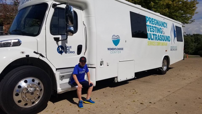 Jessica&#039;s son, Elijah, outside Women&#039;s Choice Center&#039;s mobile medical unit.
