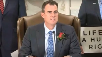Oklahoma Governor Kevin Stitt prepares to sign Senate Bill 612